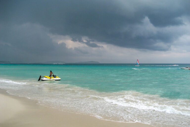 Dark stormy clouds hanging over pristine beach