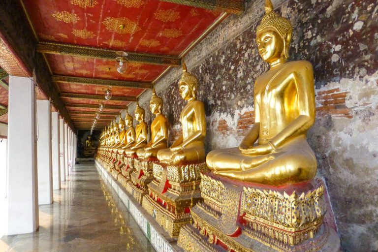 Golden Buddha statues laid out in a row