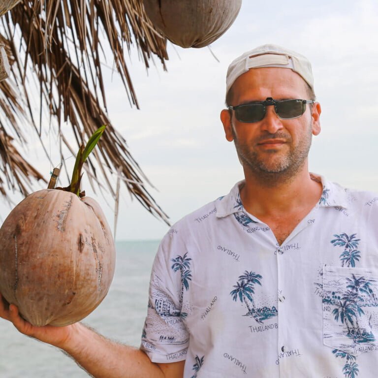 A man with a coconut on exotic island